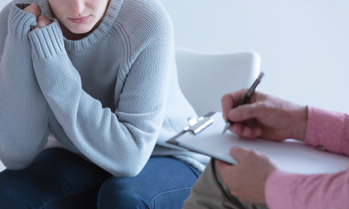 Woman sitting in therapy talking to therapist