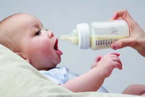 Paced bottle feeding, baby preparing to suck on a bottle
