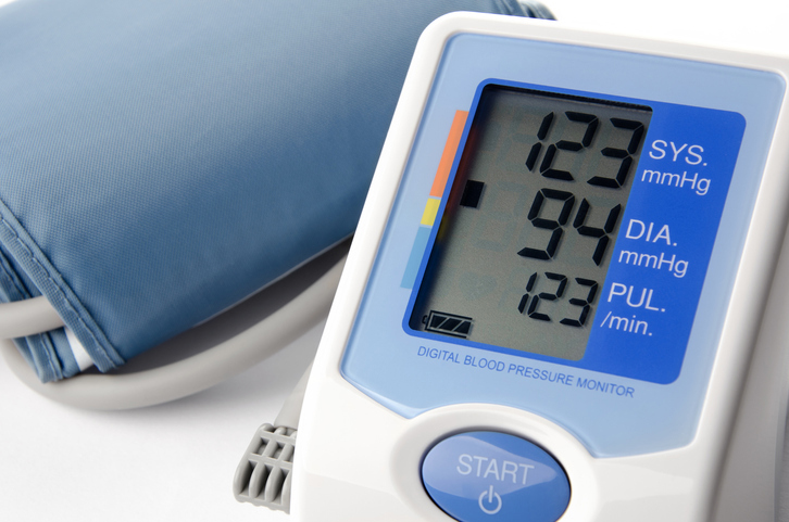 Close-up of a blood pressure cuff and monitor with results