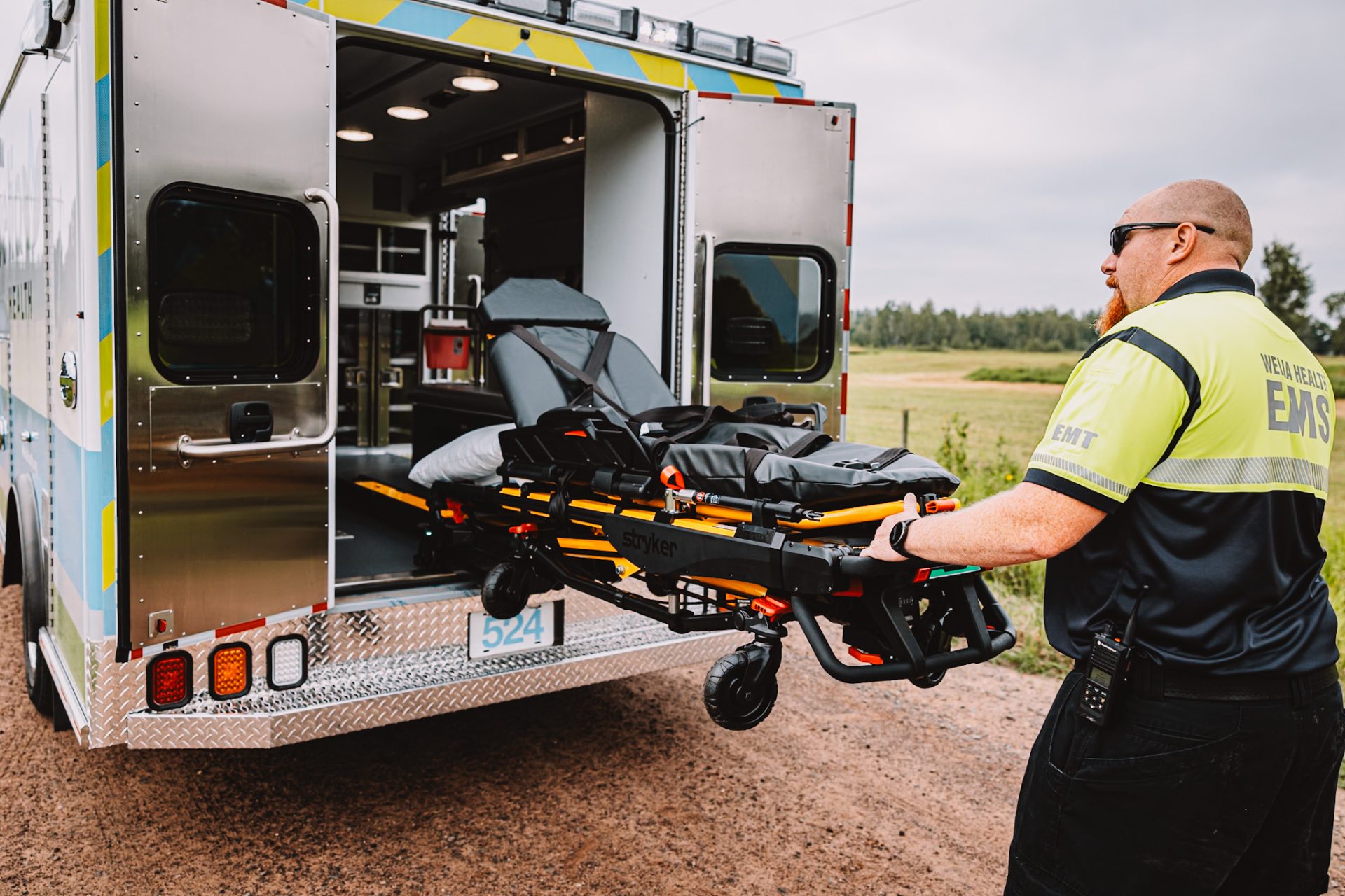 Welia Health Mike Smith putting stretcher into ambulance