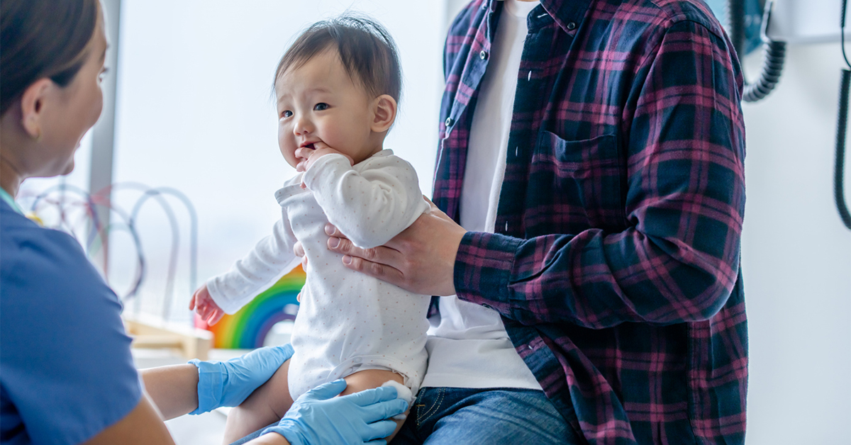 Baby in an doctor's office with his father