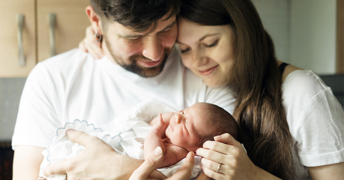 Young couple holding a newborn baby