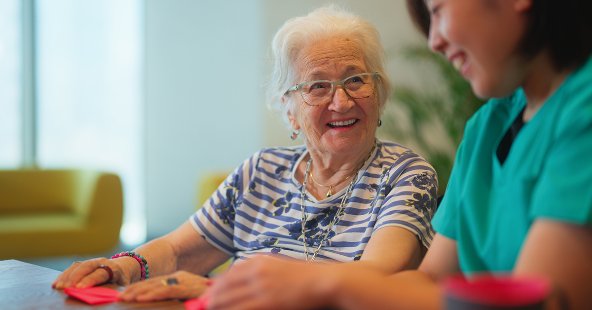 Senior female sitting with a therapist