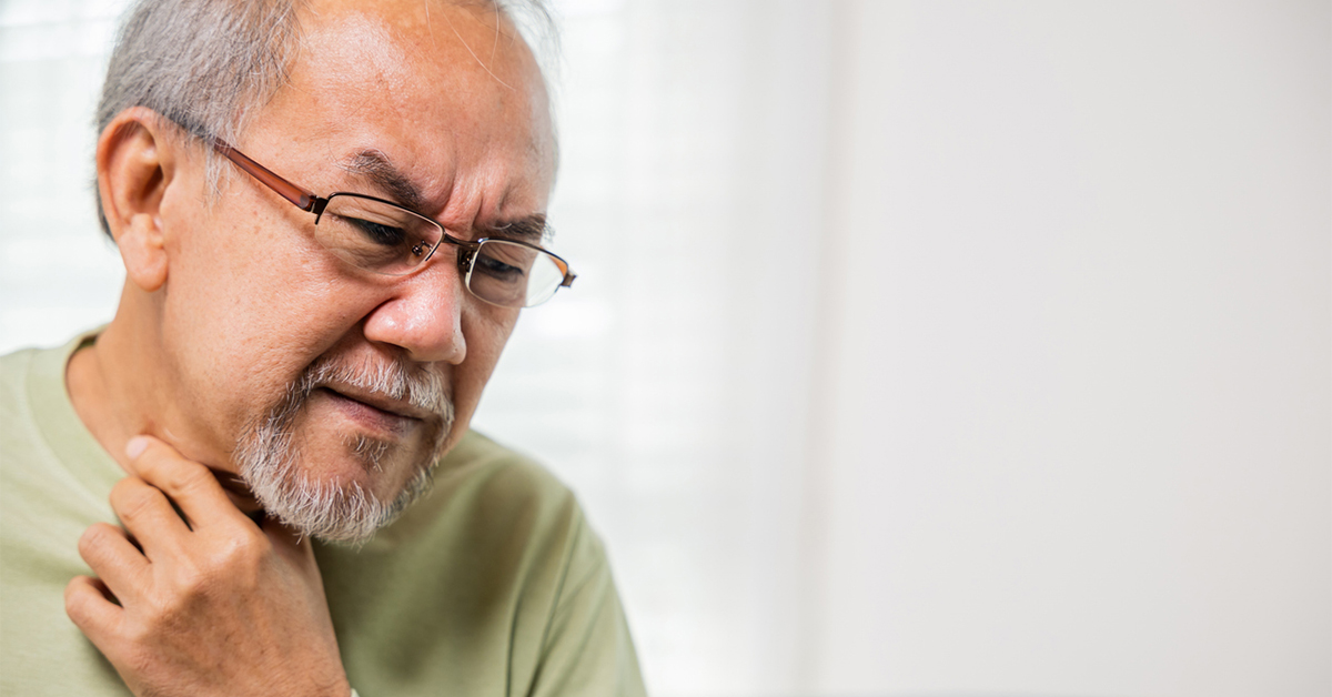 Man with difficulty swallowing and holding his throat